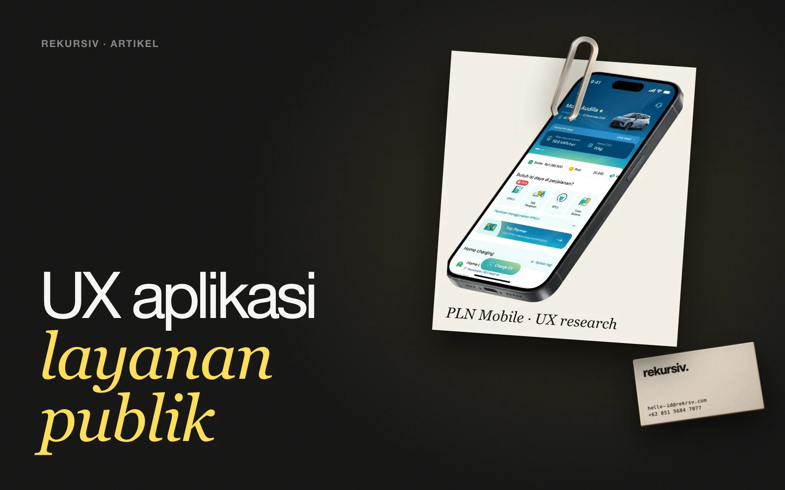 Aplikasi PLN Mobile yang baru dalam polaroid di atas meja, dengan penjepit kertas dan kartu nama rekursiv